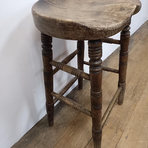 758 - A stool, with a shaped seat, on turned legs, 66 cm high