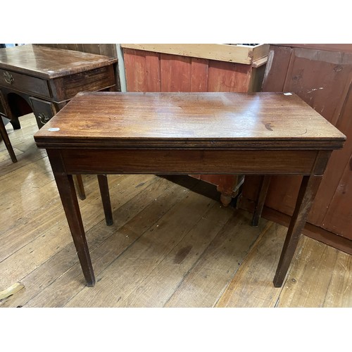 766 - A mahogany dressing table, having three drawers, 88 cm wide, and two folding card tables (3)