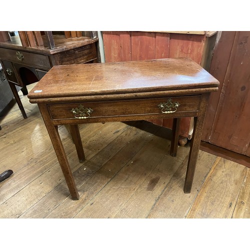 766 - A mahogany dressing table, having three drawers, 88 cm wide, and two folding card tables (3)