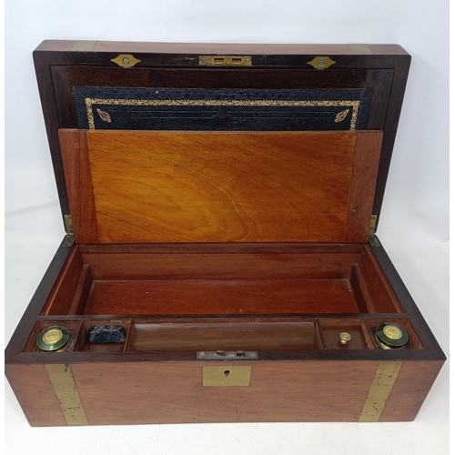 624 - A mahogany and brass bound writing box, 46 cm wide, a set of three wall lights, and three prints