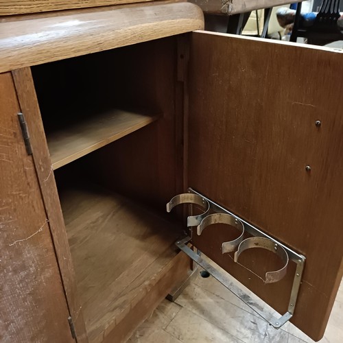 464 - An oak Art Deco dining room suite, comprising a sideboard, with two drawers and three cupboard doors... 