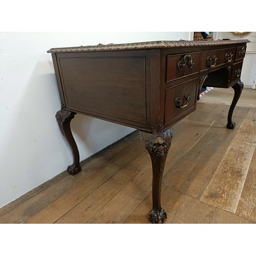 773 - A mahogany kneehole desk, having five drawers, flanked by faux drawers, on carved cabriole legs, and... 