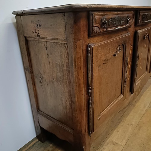 778 - A 19th century French inlaid oak dresser, having three drawers and three cupboard doors, 194 cm wide