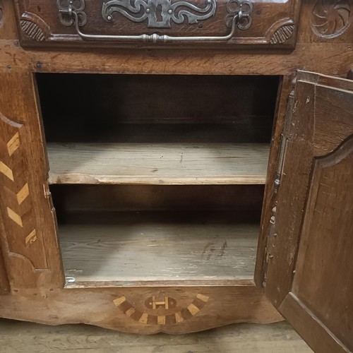 778 - A 19th century French inlaid oak dresser, having three drawers and three cupboard doors, 194 cm wide