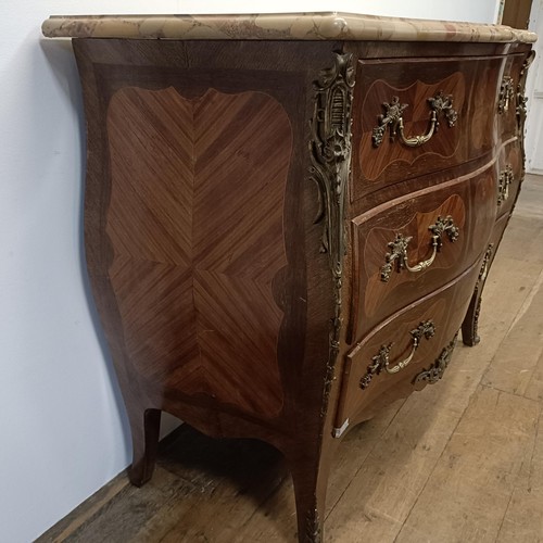 779 - A Continental parquetry inlaid rosewood bombe commode, the marble top above three drawers, with gilt... 