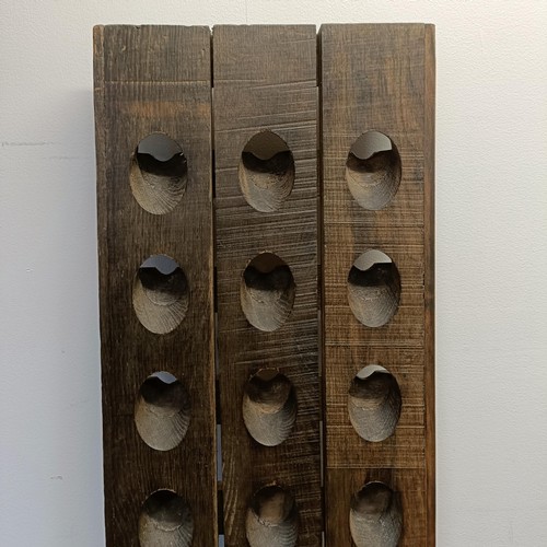 789 - A stained wood wall mounted wine rack, 150 x 37 cm