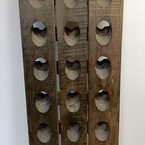 789 - A stained wood wall mounted wine rack, 150 x 37 cm