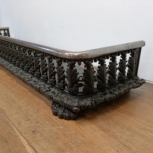 793 - A 19th century metal fender, decorated repeated foliate forms, 153 cm wide