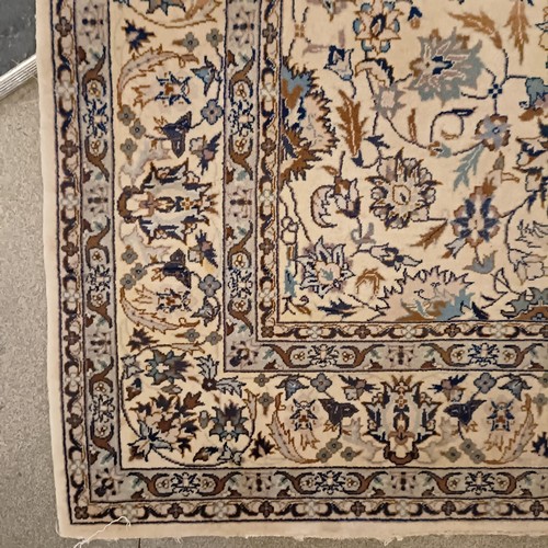 806 - A Tabriz cream ground rug, 185 x 122 cm