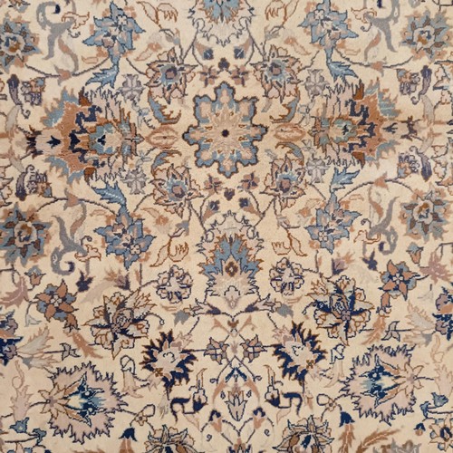 806 - A Tabriz cream ground rug, 185 x 122 cm