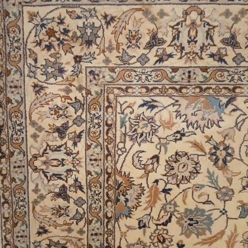 806 - A Tabriz cream ground rug, 185 x 122 cm