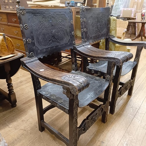 828 - A pair of Spanish oak and tooled leather armchairs (2)