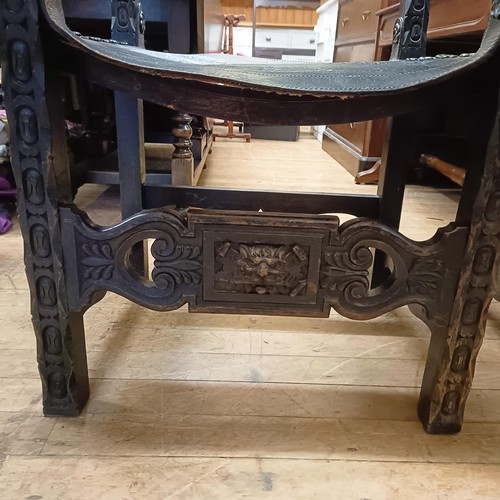 828 - A pair of Spanish oak and tooled leather armchairs (2)