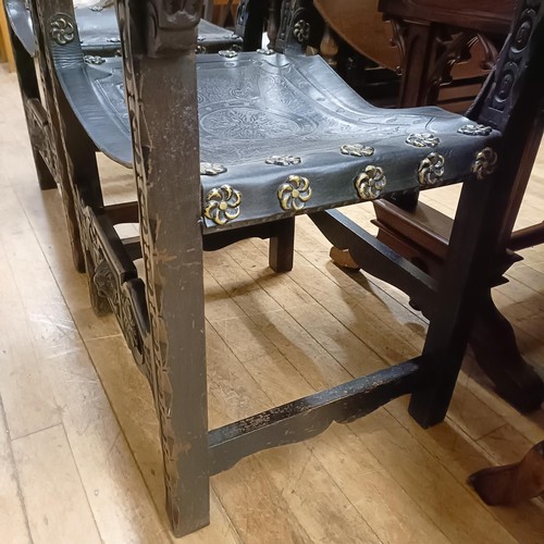 828 - A pair of Spanish oak and tooled leather armchairs (2)