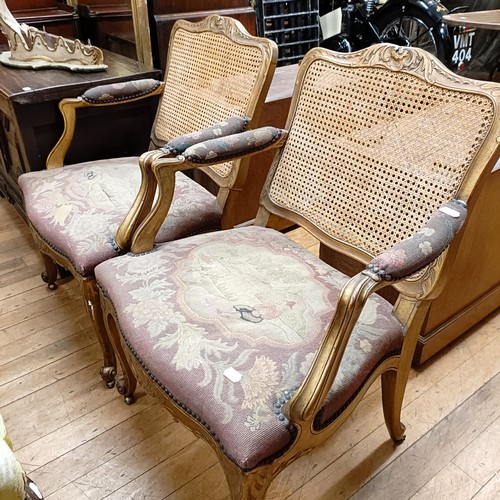 831 - A pair of gilt armchairs, with reeded backs, tapestry padded arms and seats and cabriole front legs ... 