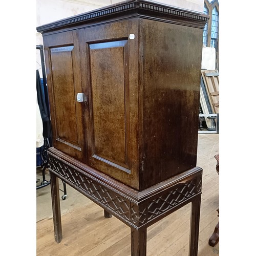 833 - An 18th century style walnut cabinet on stand, with two cupboard doors revealling a fitted interior,... 