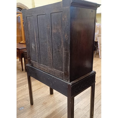 833 - An 18th century style walnut cabinet on stand, with two cupboard doors revealling a fitted interior,... 