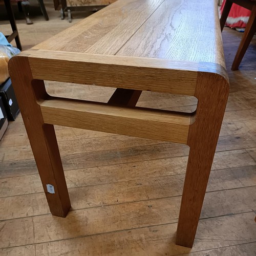 489 - A 20th century light oak bench, 183 cm wide