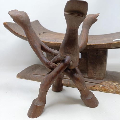 616 - An African carved stool, 49 cm wide, and a similar stand (2)