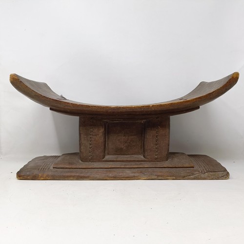 616 - An African carved stool, 49 cm wide, and a similar stand (2)