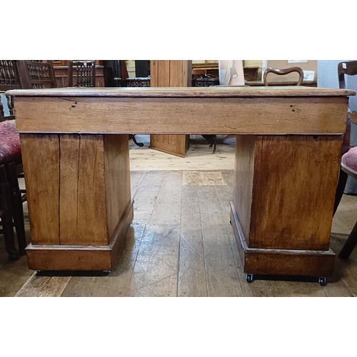 741 - An oak pedestal desk, having a nine drawer configuration, 120 cm wide