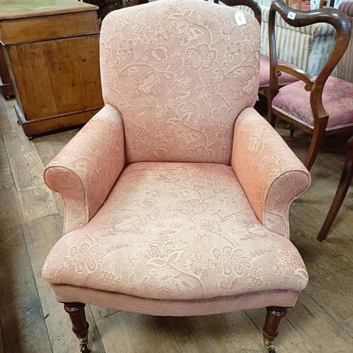 747 - A 19th century style armchair, on mahogany legs to brass castors