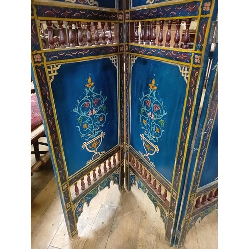 801 - A painted Moroccan four panel screen, each panel 187 x 45 cm