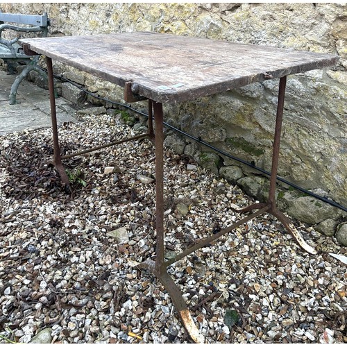 850 - A pair of metal trestle table stands, with a wooden top, 122 cm wide