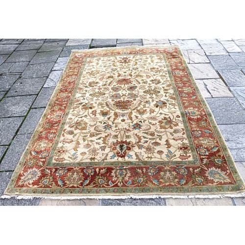 853 - A cream ground rug, 275 x 180 cm