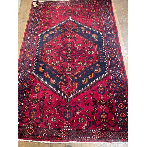 798 - A Persian type red ground rug, 210 cm x 147 cm