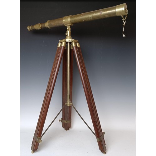 446 - A brass telescope, with a stand, a brass candelabrum, and three swords