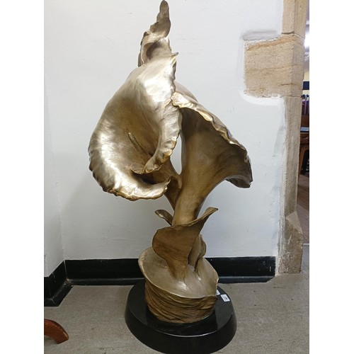 487 - Roberto Santo, a gilt bronze lily on a polished slate base, 100 cm high