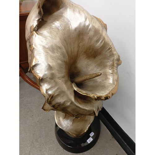 487 - Roberto Santo, a gilt bronze lily on a polished slate base, 100 cm high