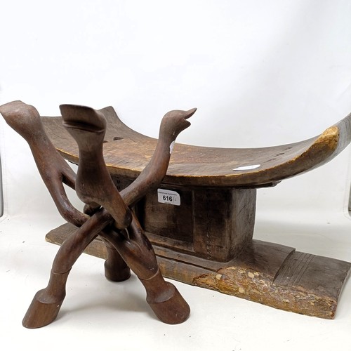 1047 - An African carved stool, 49 cm wide, and a similar stand (2)...