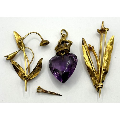 609 - Two yellow metal floral brooches, flowers removed as made of ivory, 6.4 g, and a purple stone and ye... 