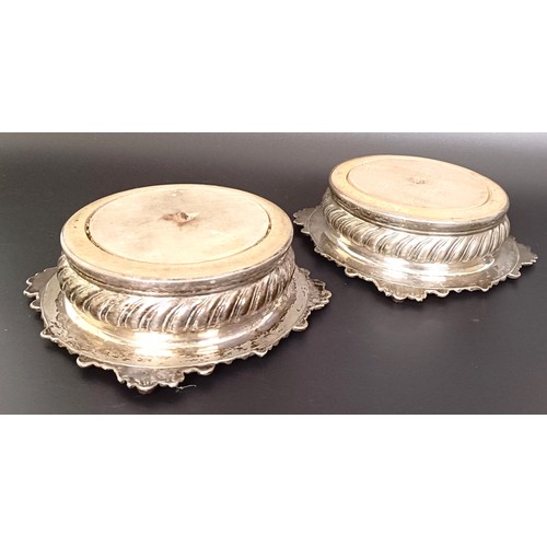 12 - A pair of Old Sheffield plate bottle coasters, with mahogany bases, 18 cm diameter (2)