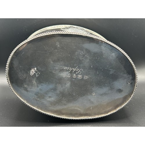 20 - A George III silver tea caddy, of oval form, decorated classical scenes, crested and inscribed, Lond... 