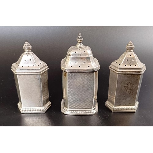 54 - A George V four piece silver cruet set, comprising three peppers, and a mustard pot, with a blue gla...