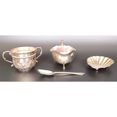 55 - A silver two handled cup, a sauce boat, a shell form dish, and a teaspoon, various dates and marks, ... 