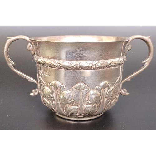 55 - A silver two handled cup, a sauce boat, a shell form dish, and a teaspoon, various dates and marks, ...