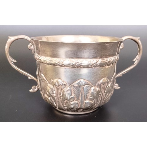 55 - A silver two handled cup, a sauce boat, a shell form dish, and a teaspoon, various dates and marks, ...