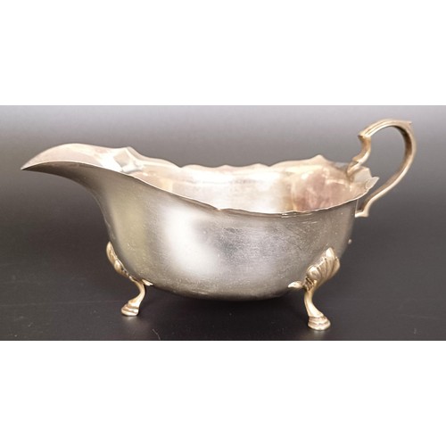 55 - A silver two handled cup, a sauce boat, a shell form dish, and a teaspoon, various dates and marks, ... 