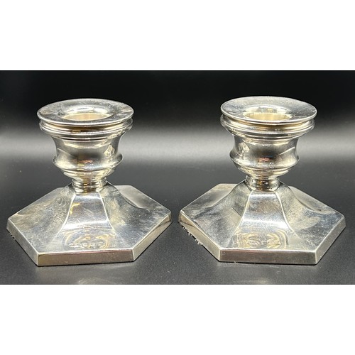 63 - A pair of Elizabeth II silver octagonal dwarf candlesticks, Birmingham 1964, 6 cm high (2)