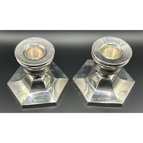 63 - A pair of Elizabeth II silver octagonal dwarf candlesticks, Birmingham 1964, 6 cm high (2)