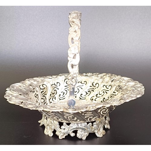 67 - A Victorian silver swing handle basket, embossed with floral and figural forms, London 1887, 5.9 ozt... 