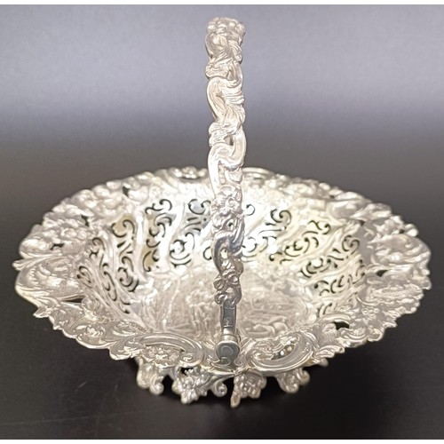 67 - A Victorian silver swing handle basket, embossed with floral and figural forms, London 1887, 5.9 ozt... 