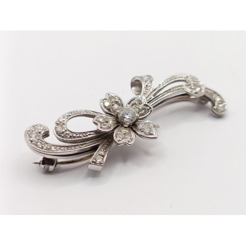 658 - A white gold and diamond flowerhead brooch