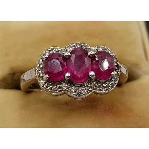 659 - An 18ct gold, ruby and diamond ring, ring size E