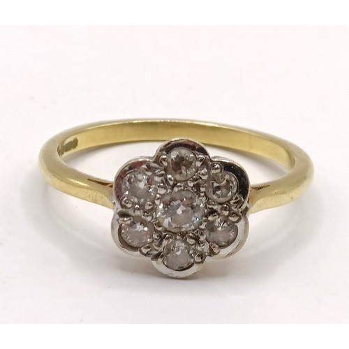 661 - An 18ct gold diamond daisy ring, ring size T