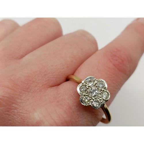 661 - An 18ct gold diamond daisy ring, ring size T